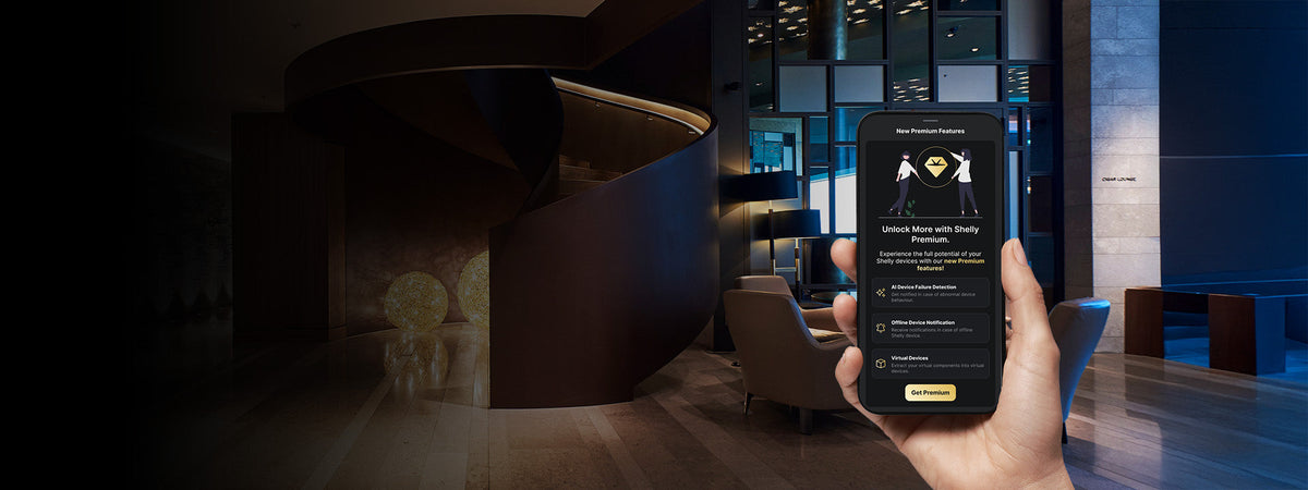 A hand holds a smartphone in a modern, dimly lit building lobby; the phone displays an app screen promoting the unlocking of premium features.