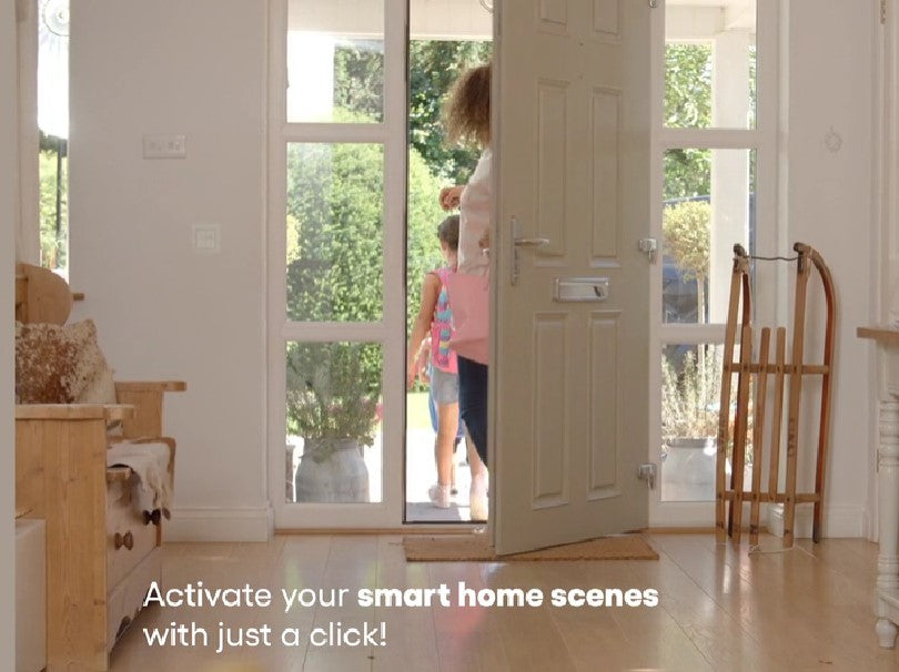 A woman stands at an open front door watching a child with a backpack step outside. The bright room has wooden furniture and a sled, with text on the image reading, Activate your smart home scenes with just a click!.