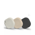 Three square-shaped Bluetooth tracking devices in white, beige, and black, each with a textured circular pattern, are displayed standing upright against a plain white background.
