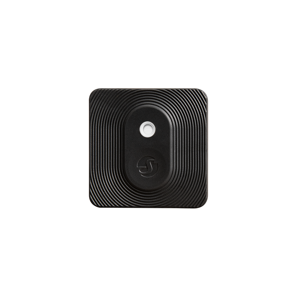 The Shelly Europe Shelly BLU H&T ZB List is a square, black, textured device with rounded corners and concentric raised lines, featuring a central circular button and a small logo below it, displayed on a plain light background.