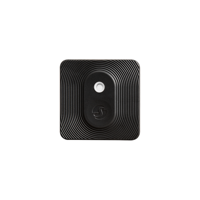 The Shelly Europe Shelly BLU H&T ZB List is a square, black, textured device with rounded corners and concentric raised lines, featuring a central circular button and a small logo below it, displayed on a plain light background.