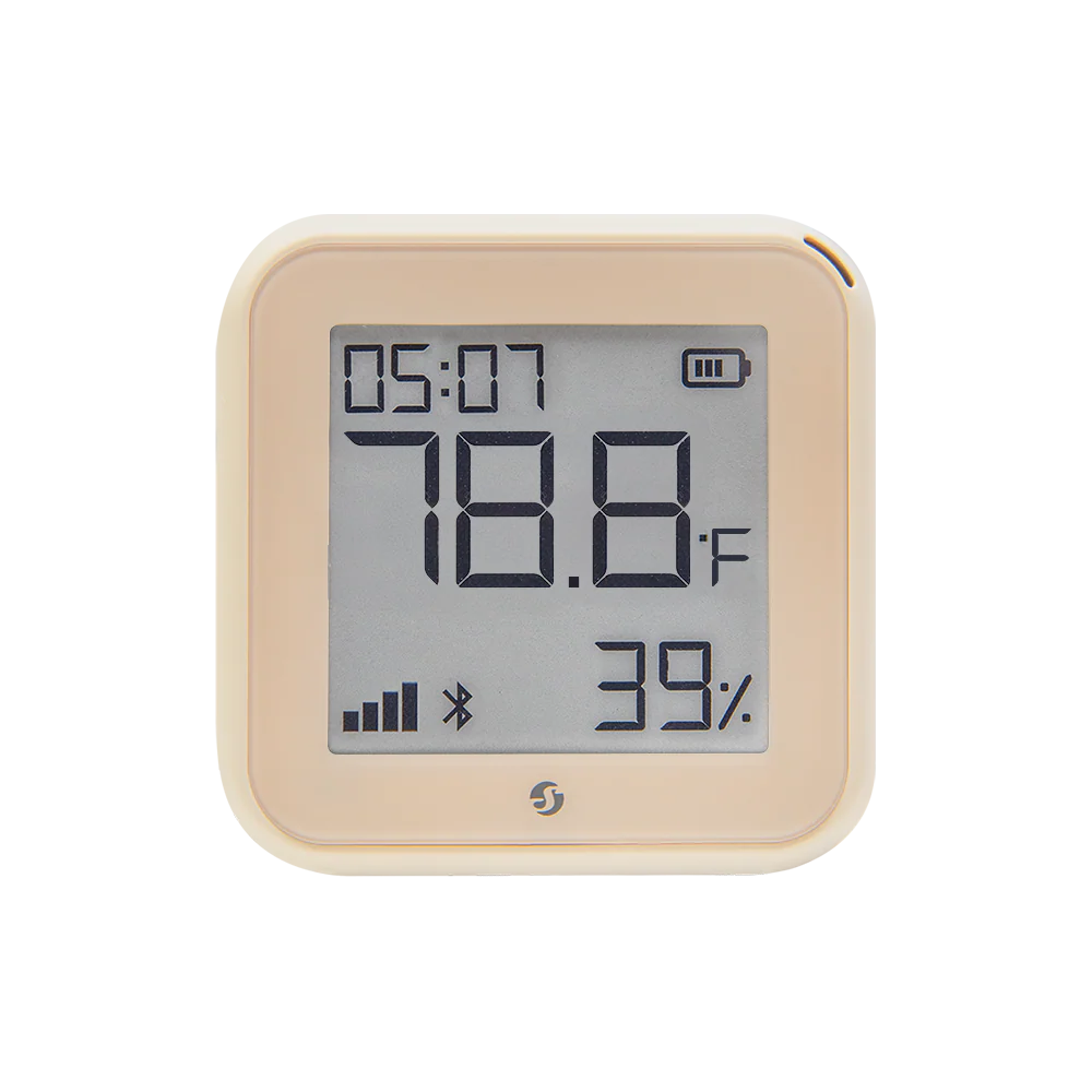 A beige digital thermometer and hygrometer displays 78.8°F, 39% humidity, the time 05:07, and Bluetooth and battery icons on its screen.