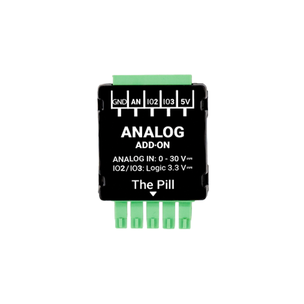 A compact black and green Analog 0 - 30V Add-on (Shelly Pill) module by Shelly USA, with labeled pins for GND, AN, IO2, IO3, and 5V, plus printed input voltage range details on its surface.