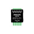 A compact black and green Analog 0 - 30V Add-on (Shelly Pill) module by Shelly USA, with labeled pins for GND, AN, IO2, IO3, and 5V, plus printed input voltage range details on its surface.