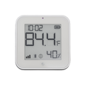 The Shelly USA Shelly BLU H&T Display ZB White shows the time (10:02), temperature (84.4°F), and humidity (40%), with battery, signal, Bluetooth, and connectivity icons on its digital screen.