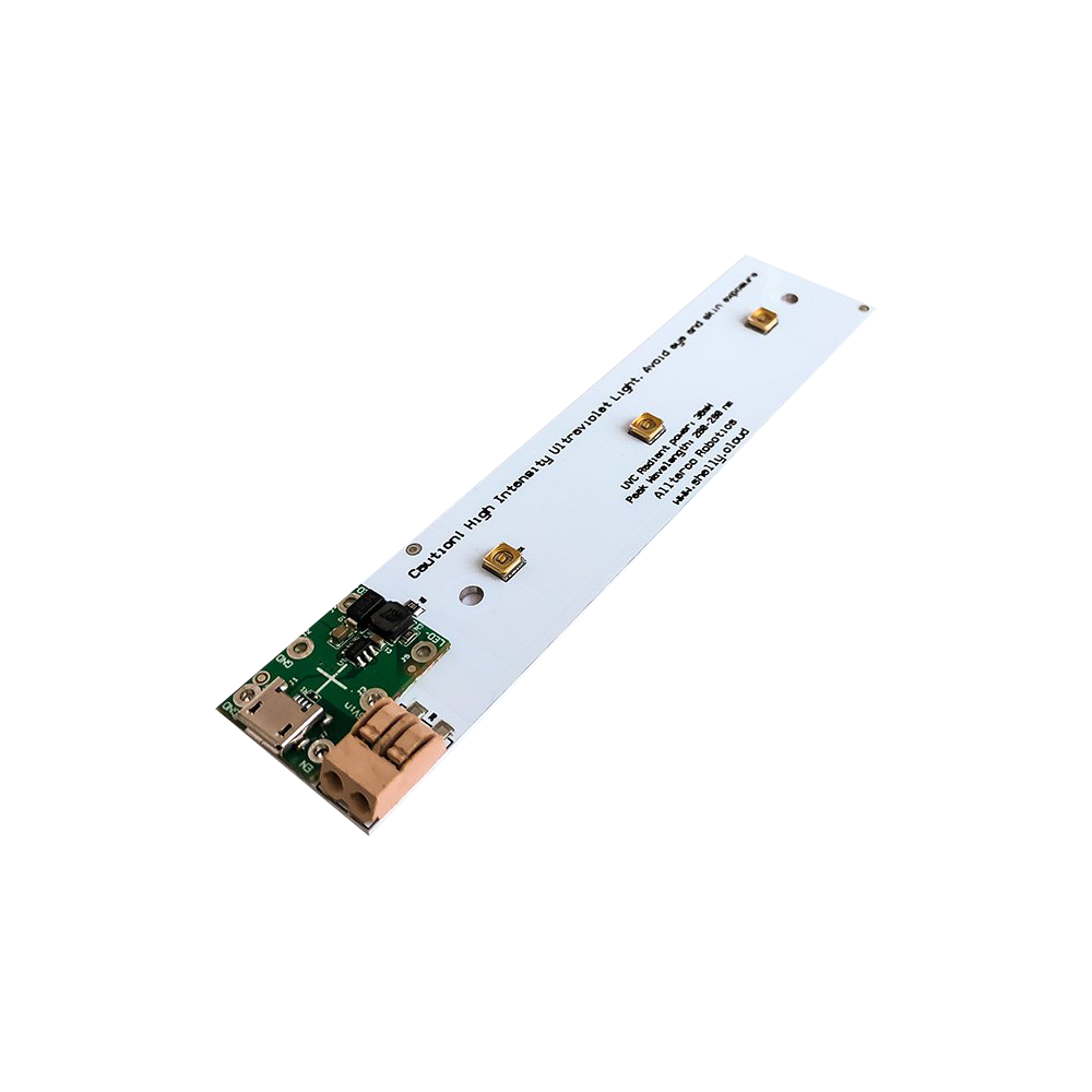 The Shelly USA USB powered UVC LED is a rectangular electronic circuit board with a white base, gold and black components, and a green section at one end. Text appears near the center. The board is shown against a plain white background.