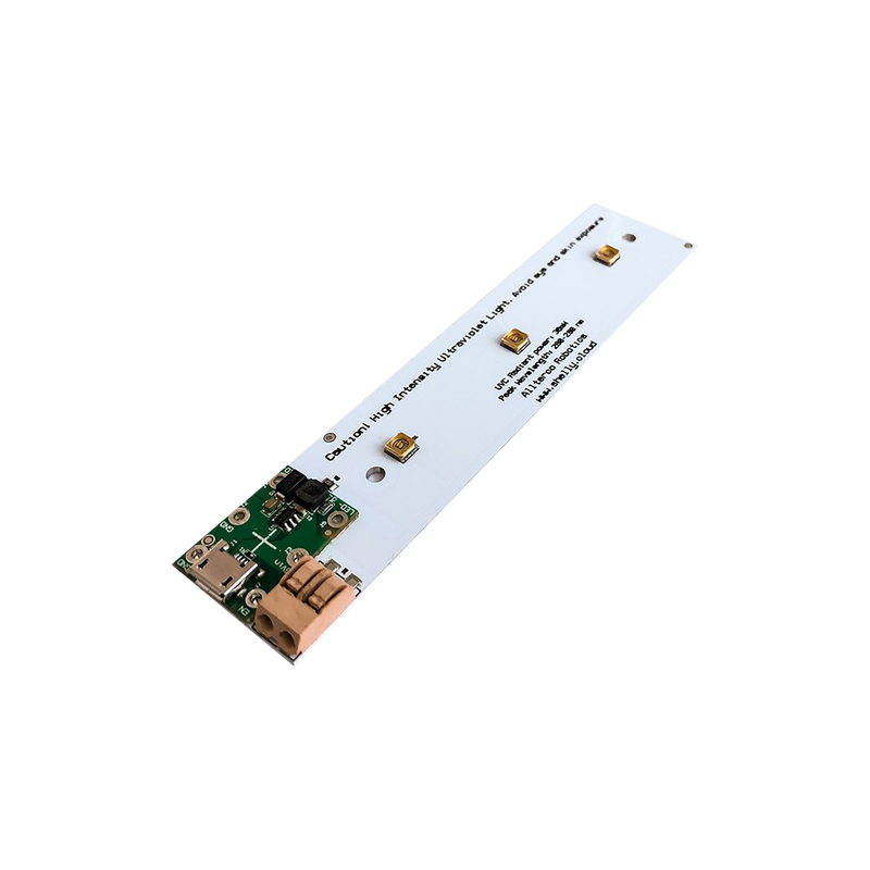 The Shelly USA USB powered UVC LED is a rectangular electronic circuit board with a white base, gold and black components, and a green section at one end. Text appears near the center. The board is shown against a plain white background.